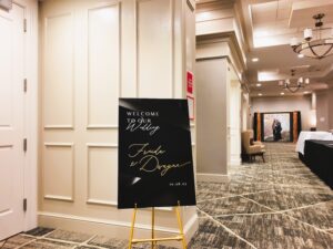 A black and gold sign in the middle of an empty room.