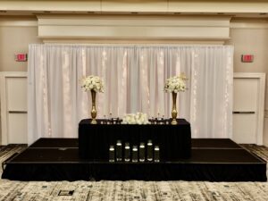 A black table with white flowers on top of it.