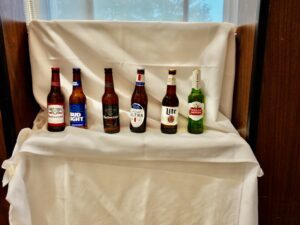 A table with several different beers on it.