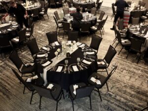 A banquet hall with tables and chairs set up for an event.