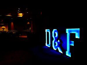 A lighted sign that says d & f.