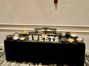 A table with sweets on it in front of a wall.