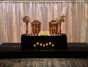 A table with candles and chairs on it