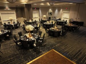 A banquet hall with tables and chairs set up for an event.