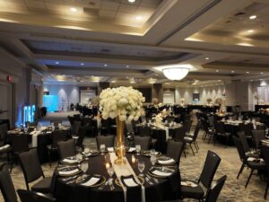 A large banquet hall with tables and chairs.