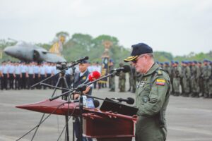 A man in military uniform speaking at an event.