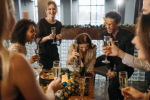 A group of people sitting around a table with wine glasses.