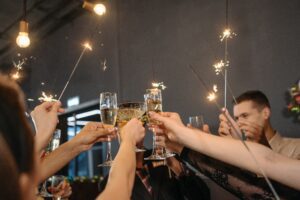 A group of people holding champagne glasses in their hands.