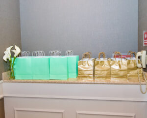 A counter top filled with blue and gold colored bags