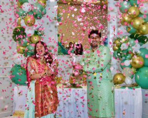 A man and a woman standing and celebrating with confetti.